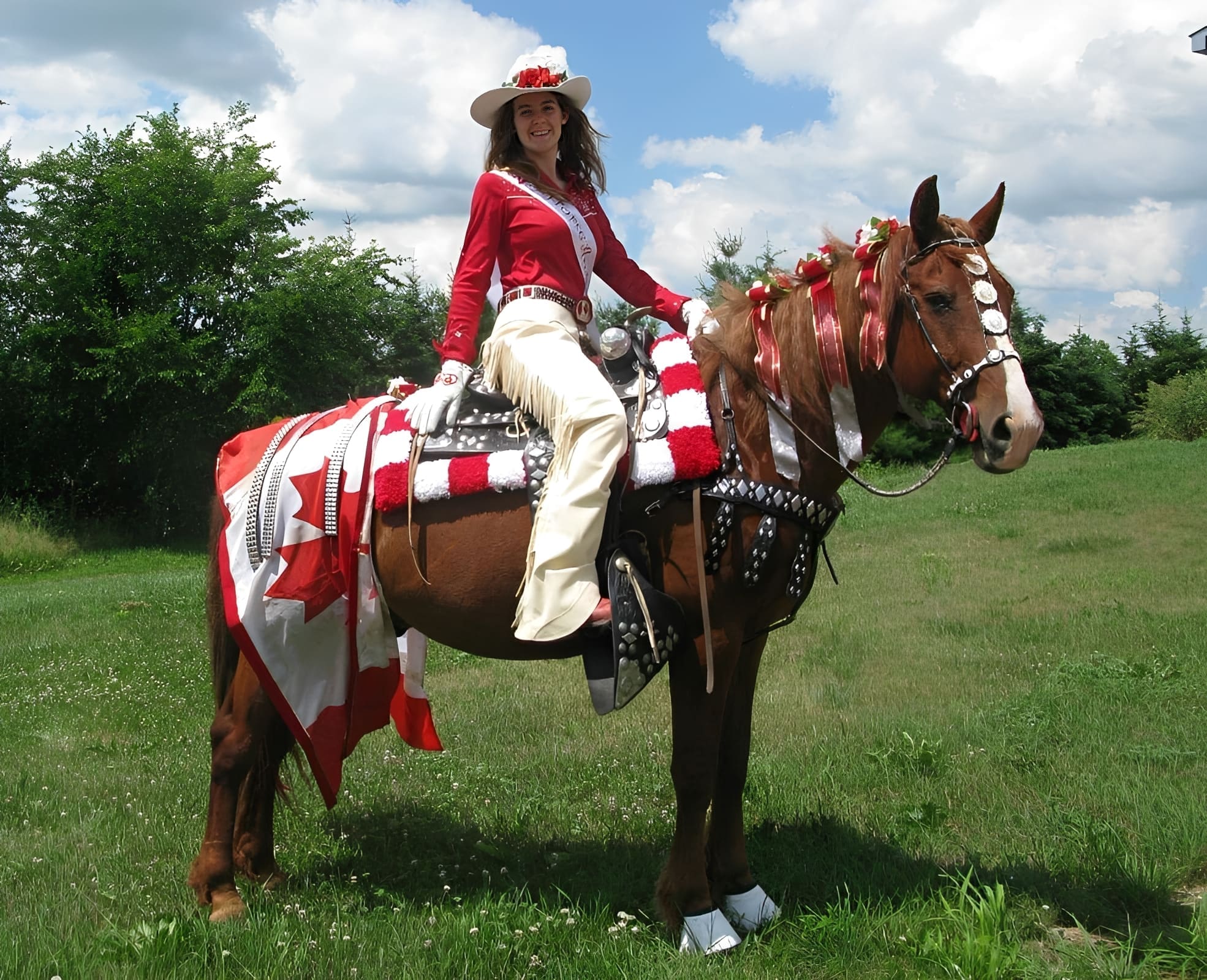 Equestrian dressed in red and white attire.