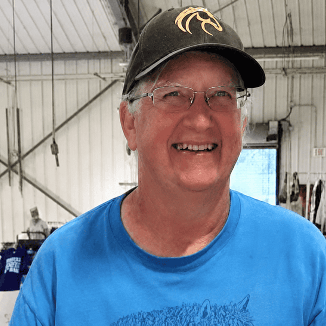 Smiling man in blue shirt and cap